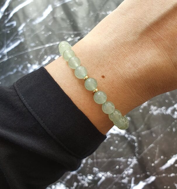 Green aventurine bracelet on wrist – gemstone jewellery for emotional calm, good fortune, and heart chakra alignment.