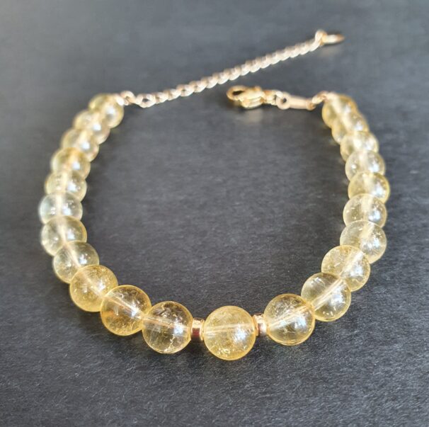 Woman wearing a citrine bracelet – crystal jewellery for wealth, confidence, and emotional positivity.
